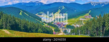 Panorama della catena del Gorgany dal Monte Bukovel, osservando i verdi pendii, coperti di prati e boschi di abete rosso, il lago Molodist e l'hotel Foto Stock