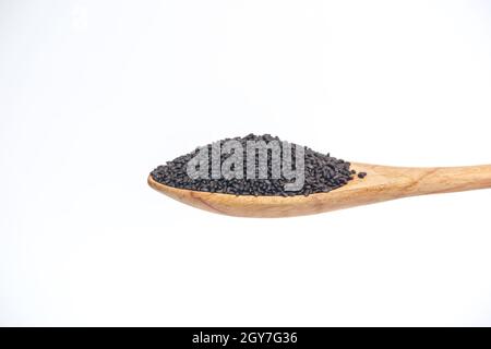 Semi di grano nel cucchiaio di legno isolato su uno sfondo bianco. Foto Stock