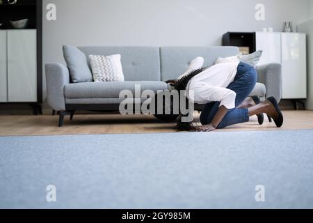 African Woman perso chiave o telefono. Ricerca di qualcosa Foto Stock