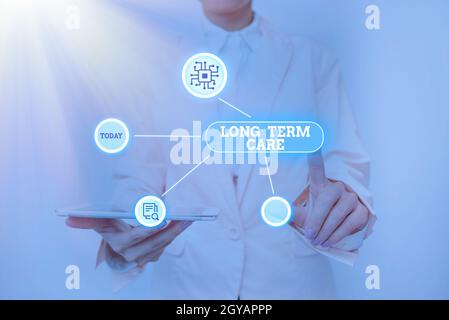 Cartello con scritto a mano Long Term Care, Business Concept Assistenza con le attività personali di base della vita quotidiana Lady Holding Tablet premere su Virtual B Foto Stock