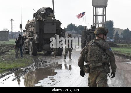 Soldati USA con Alpha Company, 3° Battaglione, 21° Regiment fanteria, 1° Team di combattimento Brigata Stryker, 21° Divisione fanteria da Fort Wainwright, Alaska smontare i loro veicoli per interagire con i membri della comunità nel nord-est della Siria, 1° gennaio 2020. I rapporti con la popolazione locale sono vitali nella lotta contro Daesh. (STATI UNITI Esercito foto di SPC. John Stauffer) Foto Stock