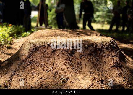 Tomba piena in strada. Sito commemorativo. Sepoltura di un soldato. Lavori di terra. Cerimonia di sepoltura. Foto Stock