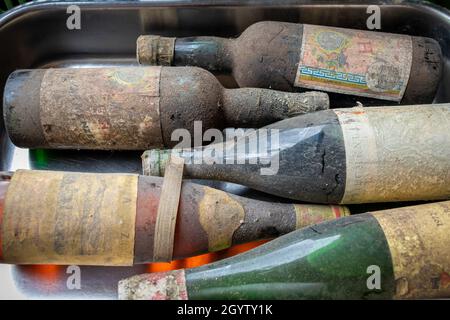 Neckargemuend, Germania - 11 settembre 2021: Bottiglie di vino molto vecchie con depositi da lunga cantina di stoccaggio come offerte in un mercato delle pulci Foto Stock