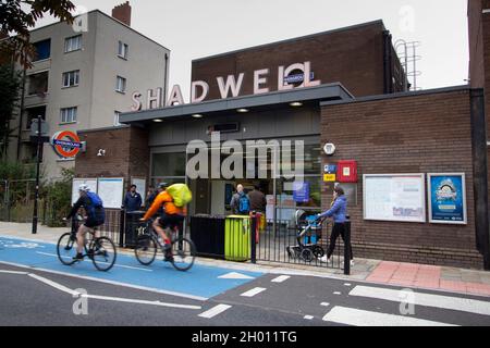 Shadwell DLR e la stazione di terra, Londra, con ciclisti e pedoni di passaggio Foto Stock