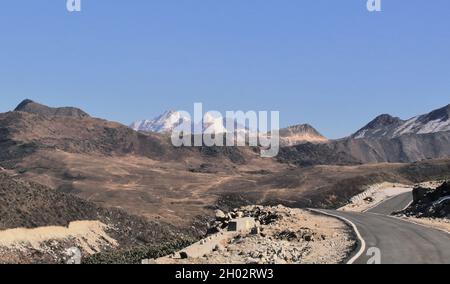 alta strada di montagna himalayana e picco innevato vicino al confine india cina (bum la pass) nel distretto di tawang di arunachal pradesh, india nord-orientale Foto Stock