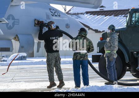 210104-N-GR586-1122 MISAWA, Giappone (Gen. 4, 2021) – Aviation Structural Mechanic Airman Apprentice Micah Holland, assegnato ai 'Black Ravens' di Electronic Attack Squadron (VAQ) 135, rifornisce un EA-18G Growler presso la Naval Air Facility Misawa. VAQ-135 fornisce aeromobili EA-18G completamente operativi per eseguire attacchi elettronici illimitati in tutto il mondo. Foto Stock