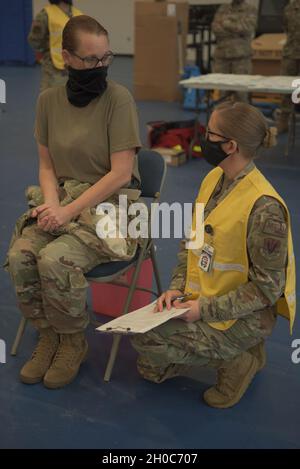 Direttore dell'aeronautica degli Stati Uniti, Sgt. Kati Grabham, 325th Fighter Wing capo comando, a sinistra, e Tech. SGT. Haley Lecomte, 325 tecnico di pronto medico operativo Squadron, destra, discuta il vaccino di Coronavirus prima della somministrazione alla base di aeronautica di Tyndall, Florida, 21 gennaio 2021. Ogni individuo che ha ricevuto il vaccino è stato preinformato su ciò che poteva aspettarsi di sperimentare una volta che il vaccino era stato somministrato. Foto Stock