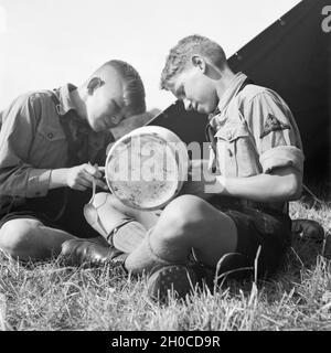 Zwei Hitlerjungen Zeltlager im beim Essen, Deutschland 1930er Jahre. Due giovani di Hitler a pranzo, Germania 1930s. Foto Stock