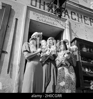 Drei junge Frauen haben in einem Uhrmachergeschäft Kunsthandwerksgegenstände eingekauft, Österreich 1930er Jahre. Tre giovani donne hanno comprato alcuni oggetti di artigianato in un orologio maker's shop, Austria 1930s. Foto Stock