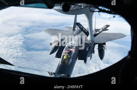 Un aereo dell'aeronautica degli Stati Uniti F-15E Strike Eagle assegnato alla 48a ala del Fighter, Lakenheath dell'aeronautica reale, Inghilterra, riceve il combustibile da un velivolo di Stratotanker di KC-135 assegnato alla 100esima ala di rifornimento dell'aria dalla RAF Mildenhall, Inghilterra, 24 febbraio 2021. Quattro aerei da combattimento F-15E hanno partecipato al volo dell'indipendenza estone, unendosi ai velivoli da addestramento L-39 e a un velivolo M-28 dell'aeronautica estone, i velivoli da combattimento Eurofighter Typhoon dell'aeronautica tedesca schierati in Estonia come parte della missione di polizia aerea del Baltico, E i jet da combattimento Eurofighter Typhoon dall'Air Fo italiano Foto Stock