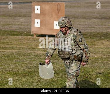 SGT. Prima classe Justin S. Rorex con 1 ° Battaglione, 214 reggimento Aviazione, 12 ° combattimento Aviazione Brigade, 'Wings of Victory,' torna alla posizione di tiro dopo aver controllato i suoi risultati durante un esercizio di fuoco in tensione di M4 Carbine, Baumholder manovra Training Area, Germania 24 febbraio 2021. Foto Stock