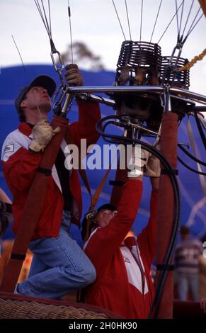 I PILOTI SI PREPARANO A RIEMPIRE UN PALLONE AD ARIA CALDA PRONTO PER UN VOLO. Foto Stock