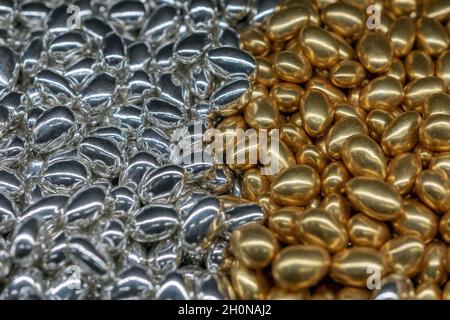 Sfondo luminoso in oro e caramelle dolci d'argento. Concetto di cibo. Foto Stock