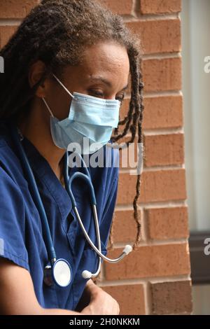 Medico femminile con lunghi temerini Foto Stock