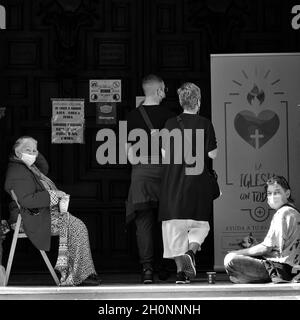 Granada, Spagna; ottobre-11, 2021: Due mendicanti che chiedono denaro alla porta di una chiesa di Granada (Spagna) Foto Stock