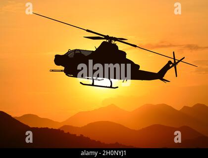 American Attack elicottero silhouette in volo Foto Stock