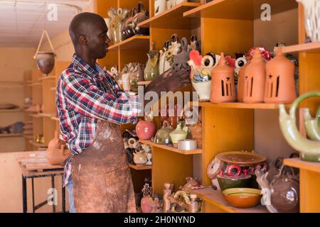 Artigiano che esamina la terracotta fatta a mano Foto Stock