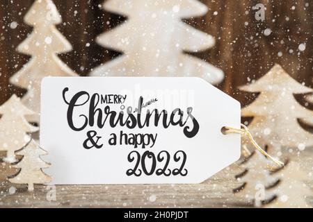 Albero di Natale, etichetta con buon Natale e felice 2022, Snowflakes Foto Stock