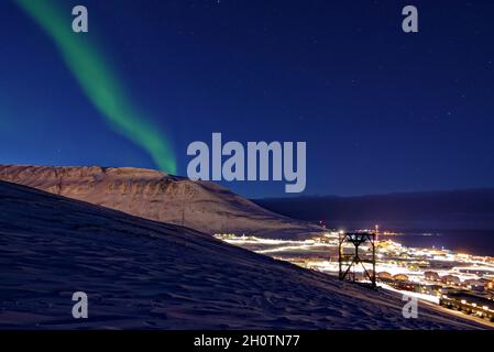 Stagione invernale scura su Svalbard con notte polare e luci del nord. Longyeaarbyen visto da una collina. Longyearbyen, Spitsbergen, Svalbard, Norvegia Foto Stock