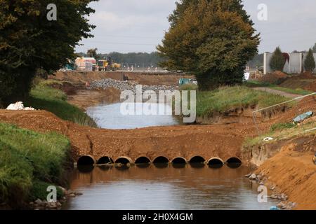 Erftstadt, Germania. 13 ottobre 2021. Il fiume Erft scorre attraverso il distretto di Blessem, e un percorso costruito su tubi vi scorre attraverso. A Erftstadt, la terra si aprì nella notte del 15 luglio e inghiottì diverse case. (A dpa: ''You take that to the grave' - Un quarto d'anno dopo l'alluvione') Credit: Oliver Berg/dpa/Alamy Live News Foto Stock