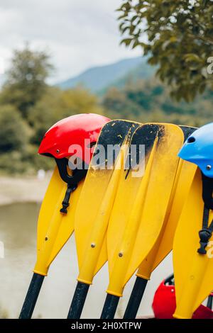 Pagaie gialle in plastica per il rafting su barche gonfiabili sul fiume Foto Stock