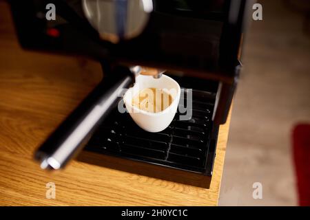 Preparazione di una tazza di caffè utilizzando una macchina espresso in un caffè, macchina da caffè preparazione di caffè espresso Foto Stock
