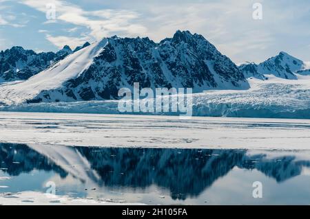 Ghiacciaio di Monaco e la sua riflessione specchio sulle acque artiche. Ghiacciaio di Monaco, Isola di Spitsbergen, Svalbard, Norvegia. Foto Stock