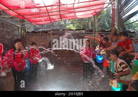 Le giovani donne e uomini Rakhain gettano acqua all'opposizione per esprimere il loro amore al Bazar di Cox in Bangladesh. Alla fine del gioco la ragazza è venuta vicino agli uomini ed esprime la loro emozione. Foto Stock