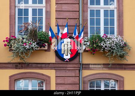 Bandiera francese su uno scudo con le lettere 'RF' per la Repubblica francese, sulla facciata del municipio di Belfort in Francia Foto Stock