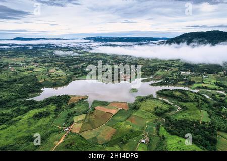 Veduta aerea del campo agricolo con nebbia e laghetto in campagna Foto Stock