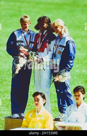 Jackie Joyner-Kersee (USA) vince la medaglia d'oro nell'eptathlon ai Giochi Olimpici estivi del 1988 con Sabine John (GDR) L argento e Anke Behmer (GDR) bronzo. Foto Stock