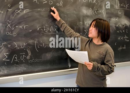 Studente cinese alla classe di matematica della lavagna MR - modello rilasciato Foto Stock