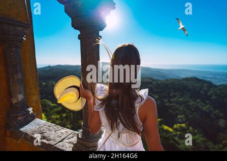 Donna turistica con cappello da sole che gode di una splendida vista a Sintra, Portogallo. Vacanze estive in Portogallo Foto Stock
