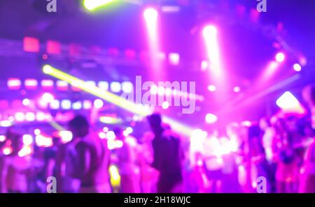 Blurred persone che ballano alla musica notte festival evento - Abtsract defocused immagine sfondo del disco club dopo la festa con laser show Foto Stock