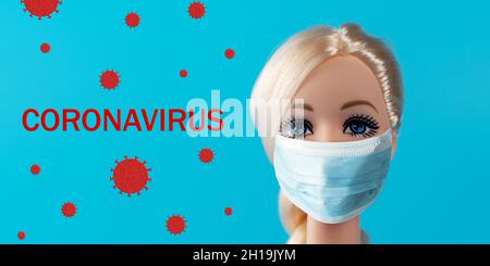Heraklion, Grecia, 13 marzo 2020: Composizione creativa con bambola con maschera virus. Epidemia minima di virus Corona. Concetto di vacanza. Foto Stock