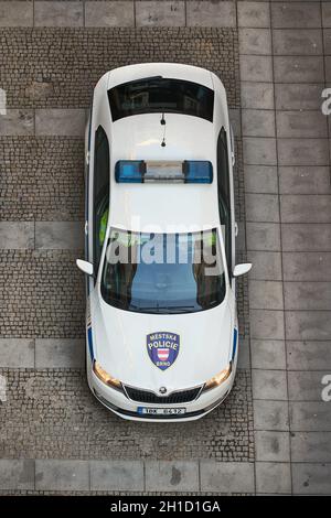 BRNO, CZECHIA - CIRCA 2019: Auto della polizia che pattina sulle strette strade del centro storico di Brno. Vista dall'alto in basso da un punto di osservazione privilegiato Foto Stock