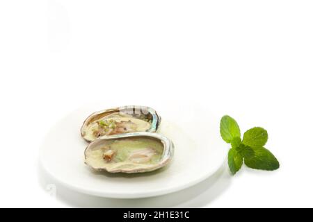Ostriche antiossidanti farcite di abalone con peperoncino servito su un grande piatto guarnito con menta in cibo tradizionale in Messico Foto Stock