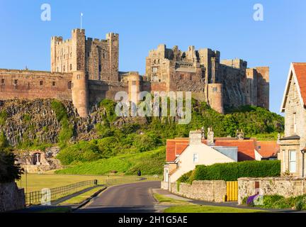 Castello di Bambburgh Northumberland Bambburgh Inghilterra guardando le pareti del Castello di Bambburgh e il Villaggio di Bambburgh case di Bambburgh Northumberland Inghilterra UK GB Foto Stock