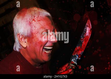Ritratto di uomo anziano sorridente pazzo con coltello. Il concetto di Halloween, assassino Foto Stock