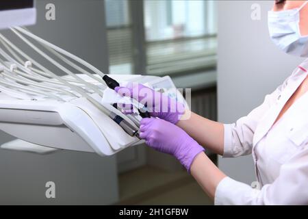 Un infermiere pulisce gli strumenti dentali. Disinfezione in odontoiatria. Foto irriconoscibile. Spazio di copia. Foto Stock