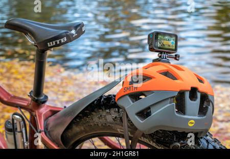 Fort Collins, CO, USA - 7 ottobre 2021: Action camera impermeabile GoPro Hero 10 montata su un casco da bicicletta, riva del fiume in autunno. Foto Stock