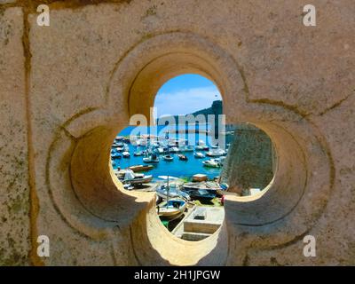 View through the fortress and marina in the old town of Dubrovnik, Croatia. Dubrovnik is a UNESCO World Heritage site Stock Photo