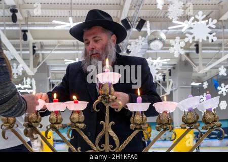 02.09.2019 Kiev, Ucraina. Il rabbino capo della città di Kiev Jonathan Markovich accende le candele con i bambini al festival di Hanukkah Foto Stock