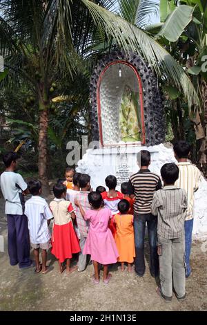 Gruppo di giovani cattolici bengalesi pregano davanti a una statua della Beata Vergine Maria, Basanti, Bengala Occidentale, India Foto Stock