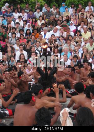 Uluwatu, Indonesia - December 27, 2008: The spectators and performers are participating in traditional religious dance Kecak at Uluwatu, Indonesia on Stock Photo