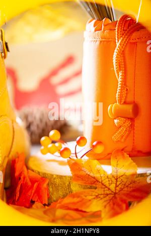 Hunter sacchetto arancione su una lastra di legno accanto all'arancione e bacche rosse e foglie e uno stivale con un pinecone e una mano rossa tacchino sullo sfondo Foto Stock