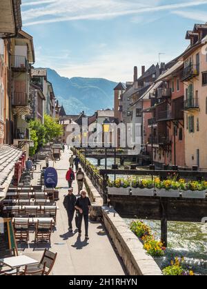 Annecy, France - May 25, 2016: People walking along river Thiou in city centre of Annecy, capital of Haute Savoie province in France. Annecy is known Stock Photo