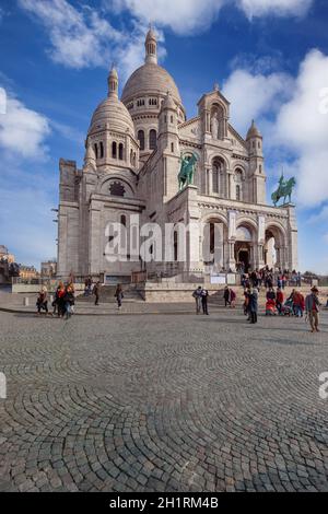 Parigi - 6 aprile 2013: Turisti vicino alla Basilica del Sacro cuore di Parigi (Sacre-Coeur). È il punto più alto della città e la terra popolare Foto Stock