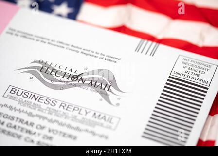 Vote-by-Mail Ballot Envelope che posa sulla bandiera americana. Foto Stock