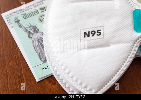 N95 maschera medica per il viso poggiata su IRS Covid-19 controllo economico di rilievo Foto Stock